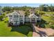 Inviting two-story home with double balconies, a charming front porch, and a meticulously landscaped lawn at 766 Bayshore Dr, Terra Ceia, FL 34250