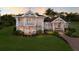 Stunning two-story home with a balcony, white railings, and a lush green lawn at 766 Bayshore Dr, Terra Ceia, FL 34250