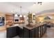 Spacious kitchen boasts an island with bar seating, custom cabinets, and open layout into the living area at 766 Bayshore Dr, Terra Ceia, FL 34250