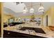 Spacious kitchen featuring granite countertops, a cooktop, and plenty of natural light from skylights and windows at 766 Bayshore Dr, Terra Ceia, FL 34250