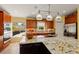 Modern kitchen with granite countertops, custom cabinets, stainless steel appliances, and a view of the backyard at 766 Bayshore Dr, Terra Ceia, FL 34250