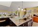 Spacious kitchen featuring a granite countertop island, stainless steel appliances, and custom wood cabinetry at 766 Bayshore Dr, Terra Ceia, FL 34250
