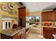 Elegant kitchen with custom cabinetry, granite countertops, and views of outdoor patio at 766 Bayshore Dr, Terra Ceia, FL 34250