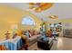 Well-lit living room with ocean-themed decor, ceiling fans, a large arched window, and views of the water at 766 Bayshore Dr, Terra Ceia, FL 34250