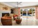 Cozy living room featuring a fireplace, comfortable seating, and views of the pool area at 766 Bayshore Dr, Terra Ceia, FL 34250