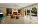 Inviting living room with wicker chairs, a fireplace, and sliding doors to a private pool at 766 Bayshore Dr, Terra Ceia, FL 34250