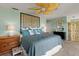 Bright main bedroom featuring a ceiling fan, bamboo headboard, and coastal-themed decor at 766 Bayshore Dr, Terra Ceia, FL 34250