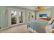 This coastal-themed main bedroom offers stunning waterfront views and access to a private balcony at 766 Bayshore Dr, Terra Ceia, FL 34250