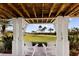 Outdoor patio area featuring columns, brick pavers, tropical landscaping, and scenic views at 766 Bayshore Dr, Terra Ceia, FL 34250