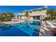 Expansive pool area featuring a large pool, comfortable lounge chairs, and lush tropical landscaping at 766 Bayshore Dr, Terra Ceia, FL 34250