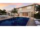 Backyard pool reflects the home's exterior, complemented by a brick patio and seating area at 766 Bayshore Dr, Terra Ceia, FL 34250