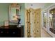 This stylish room features custom shell decor, a vintage folding screen, and access to the balcony at 766 Bayshore Dr, Terra Ceia, FL 34250