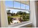 Beautiful view of the manicured lawn, patio and landscaping seen through the large window at 766 Bayshore Dr, Terra Ceia, FL 34250