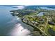 Aerial shot of waterfront property with boat docks along the coast, surrounded by lush greenery at 766 Bayshore Dr, Terra Ceia, FL 34250