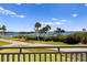 Scenic waterfront view from the balcony showcasing lush landscaping and a serene body of water at 766 Bayshore Dr, Terra Ceia, FL 34250