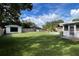 Sprawling backyard features a detached garage, a fenced-in lawn, enclosed porch, and private pool oasis at 7735 Westmoreland Dr, Sarasota, FL 34243