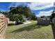Fully fenced backyard features a pool, detached garage, and meticulously maintained lawn at 7735 Westmoreland Dr, Sarasota, FL 34243