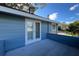 Private balcony with blue siding perfect for enjoying outdoor views and relaxation at 7735 Westmoreland Dr, Sarasota, FL 34243
