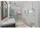 Modern bathroom features marble tile, a sleek glass shower, and updated fixtures for a spa-like feel at 7735 Westmoreland Dr, Sarasota, FL 34243