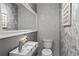 Modern bathroom featuring unique textured walls, a stylish mirror, and a sink with a wooden shelf at 7735 Westmoreland Dr, Sarasota, FL 34243