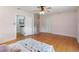 Spacious bedroom with hardwood floors, a ceiling fan, and natural light for a cozy and inviting atmosphere at 7735 Westmoreland Dr, Sarasota, FL 34243
