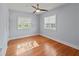 Bedroom featuring hardwood floors, two windows, and neutral paint at 7735 Westmoreland Dr, Sarasota, FL 34243