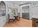 Cozy breakfast nook featuring a charming table, chairs, a built-in cabinet, and a stainless steel refrigerator at 7735 Westmoreland Dr, Sarasota, FL 34243
