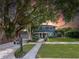 A charming two-story home with lush landscaping, a well-manicured lawn, and a classic mailbox at 7735 Westmoreland Dr, Sarasota, FL 34243