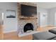 Close-up of a brick fireplace with a mounted TV and decorative mantel at 7735 Westmoreland Dr, Sarasota, FL 34243