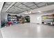 A spacious two-car garage with epoxy floors, shelving, and ample storage space for tools and equipment at 7735 Westmoreland Dr, Sarasota, FL 34243
