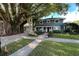Beautiful home featuring a mature banyan tree, lush lawn and a welcoming entrance at 7735 Westmoreland Dr, Sarasota, FL 34243