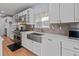 Beautiful kitchen featuring stainless steel appliances, an apron sink, and white countertops and cabinetry at 7735 Westmoreland Dr, Sarasota, FL 34243