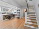 Bright open-concept kitchen featuring a brick island with bar seating and hardwood floors and staircase at 7735 Westmoreland Dr, Sarasota, FL 34243