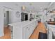 Well-lit kitchen showcasing a large island with quartz countertops and stainless-steel appliances at 7735 Westmoreland Dr, Sarasota, FL 34243