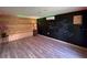 View of the outbuilding featuring wood paneling, a chalkboard wall, vinyl floors, and LED strip lighting at 7735 Westmoreland Dr, Sarasota, FL 34243