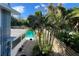 A beautiful backyard pool is surrounded by tropical plants and privacy fence, perfect for outdoor relaxation at 7735 Westmoreland Dr, Sarasota, FL 34243