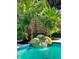 The backyard pool with a waterfall feature surrounded by lush greenery at 7735 Westmoreland Dr, Sarasota, FL 34243