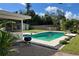 Backyard featuring a pool, patio area, with a grill on the side and landscaped surroundings at 7735 Westmoreland Dr, Sarasota, FL 34243