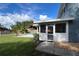 Enclosed porch with white trim and screening offers views of the meticulously maintained backyard and private pool at 7735 Westmoreland Dr, Sarasota, FL 34243