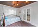 Bright sunroom with brick floors, wood ceilings, ample natural light, and a decorative bed at 7735 Westmoreland Dr, Sarasota, FL 34243