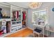 Custom walk-in closet with ample storage, a vanity, and natural light for easy organization at 7735 Westmoreland Dr, Sarasota, FL 34243