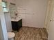 Bathroom featuring a floating vanity with a vessel sink and a wood-look tile floor at 775 36Th S Ave, St Petersburg, FL 33705