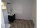 Bathroom features modern vanity with sleek black finishes and tiled floors at 775 36Th S Ave, St Petersburg, FL 33705