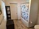 Bright bathroom with white bathtub, wood look tile floor, and modern accessories, creating a clean and inviting space at 775 36Th S Ave, St Petersburg, FL 33705