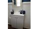 Close up of a modern, white vessel sink with a chrome faucet in a bathroom with white tiled walls at 775 36Th S Ave, St Petersburg, FL 33705