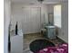 A bedroom with a minimalist design featuring neutral walls, a closet, vanity, and stylish flooring at 775 36Th S Ave, St Petersburg, FL 33705