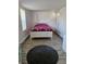 Bedroom with natural light, wood-look tile floor, and white painted walls and door at 775 36Th S Ave, St Petersburg, FL 33705