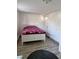 Cozy bedroom with neutral walls, featuring a bed with vibrant bedding and modern tile flooring at 775 36Th S Ave, St Petersburg, FL 33705