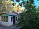 Charming cottage-style home with a mix of stone and painted siding, and lush tropical landscaping at 775 36Th S Ave, St Petersburg, FL 33705