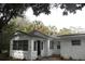 Home exterior with stone details and black door. The home is surrounded by mature trees at 775 36Th S Ave, St Petersburg, FL 33705